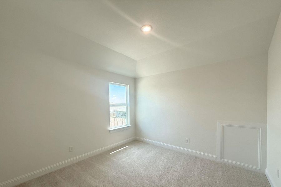 Neutral-toned room featuring a single window with white trim, recessed lighting, and light-colored carpet flooring Neutral-toned room featuring a single window with white trim, recessed lighting, and light-colored carpet flooring