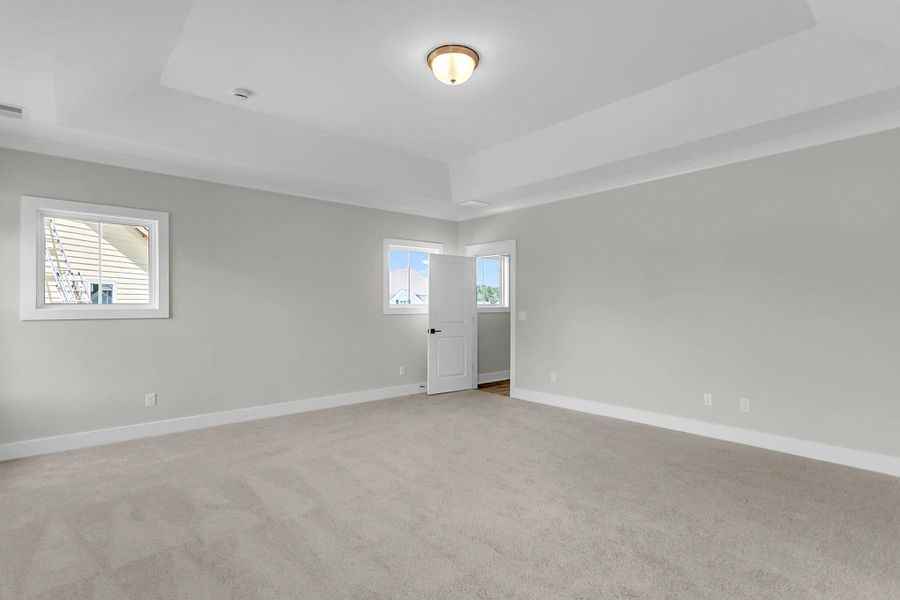 Spacious, unfurnished interior of a new home in Tidewater at Lakes of Cane Bay, Summerville (Image 55).