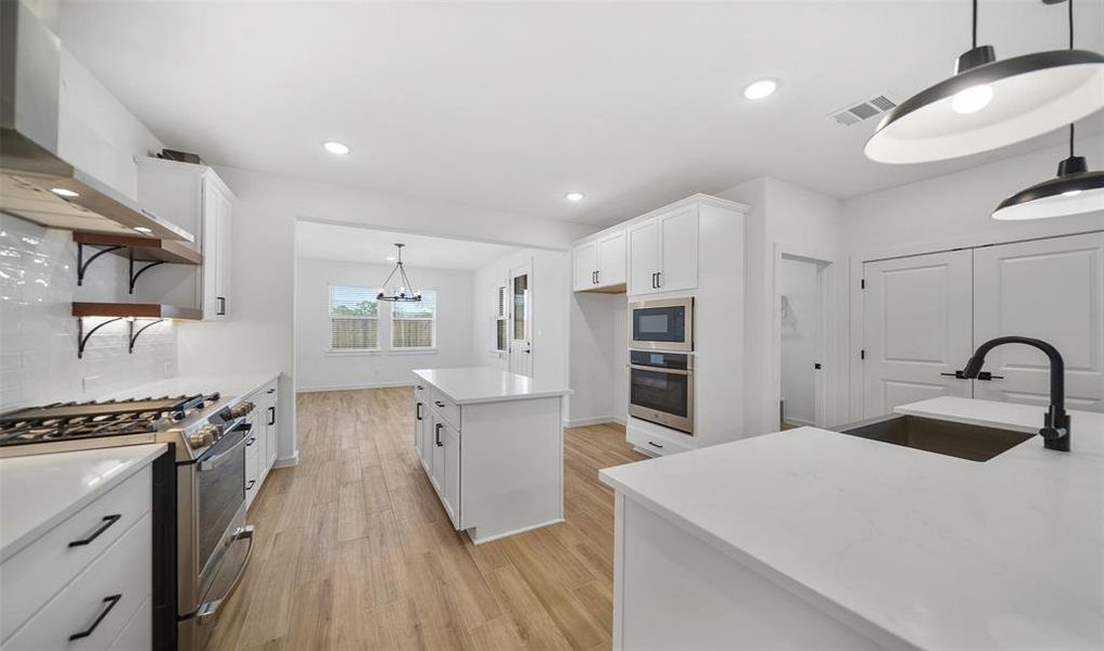 Kitchen with island (*Photo not of actual home and used for illustration purposes only.)