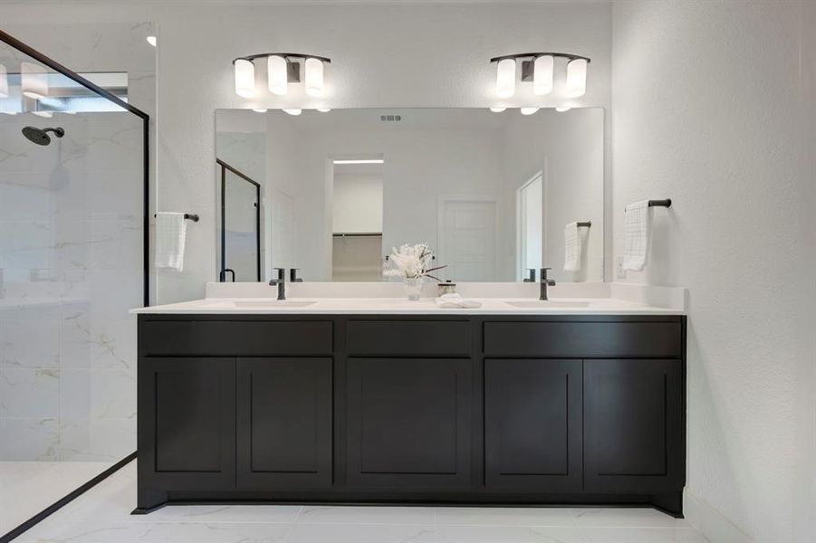 Bathroom with double vanity and a marble finish shower Bathroom with double vanity and a marble finish shower