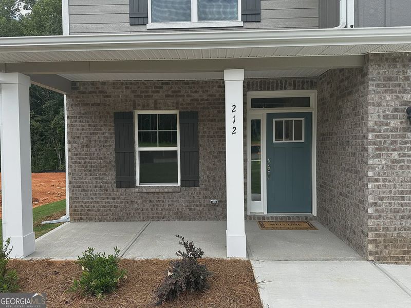 Front exterior of a new home in Canterbury Villas, Carrollton, GA, highlighting curb appeal (Image 2).