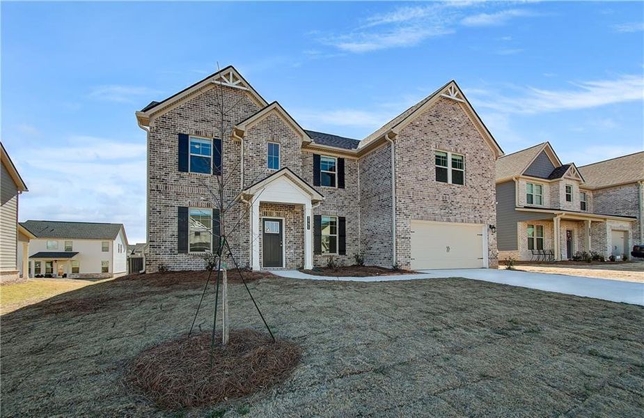 Front exterior of a new home in Adagio, Dacula, GA, highlighting curb appeal (Image 2).