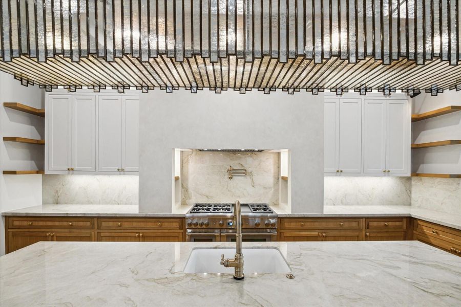 Artisan plastered oversized vent hood over gas range*Picture is of a recently constructed home by the builder.  1519 Candlelight will be similar in quality, but these pictures are not meant to be an exact representation of the new home. Specs of home may change at sole discretion of the seller.