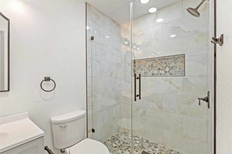 Bathroom with vanity and a shower stall