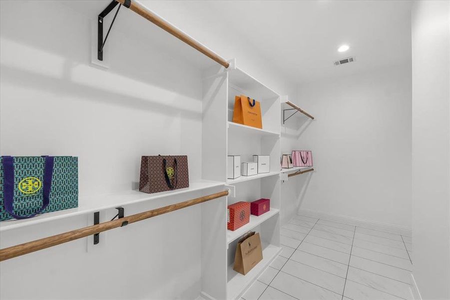 Spacious closet featuring light tile patterned flooring