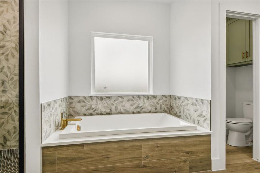 Full bath with a garden tub and a shower Full bath with a garden tub and a shower