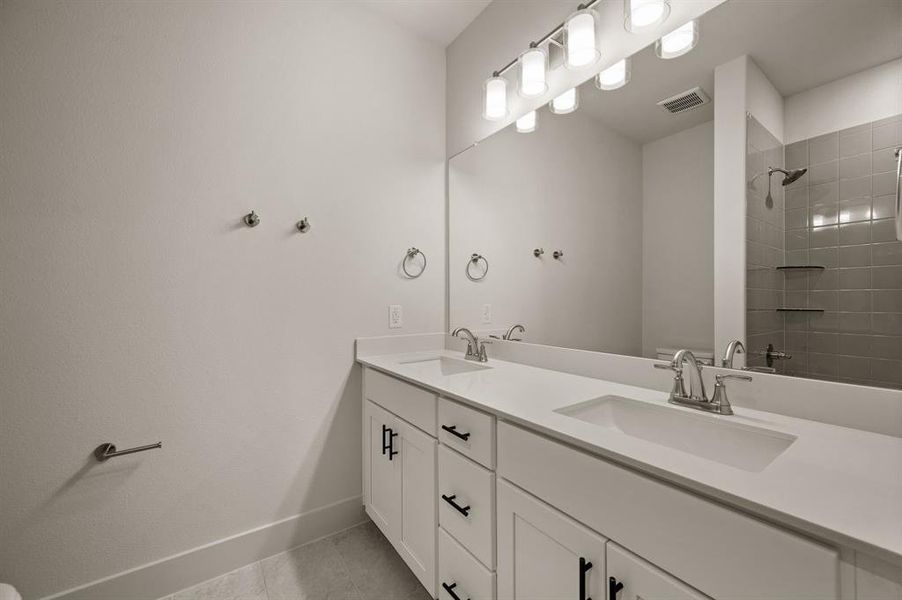 Guests will enjoy their own vanity space in this thoughtfully designed guest bath.