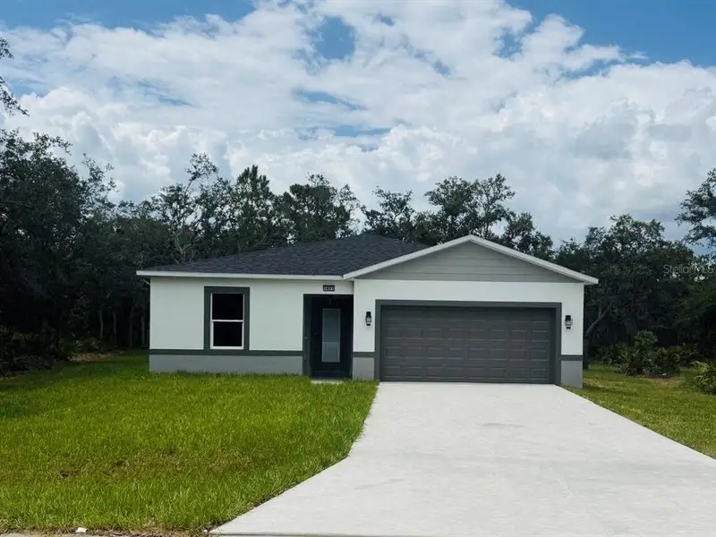 Front exterior of a new home in , Poinciana, FL, highlighting curb appeal (Image 1). Front exterior of a new home in , Poinciana, FL, highlighting curb appeal (Image 1).