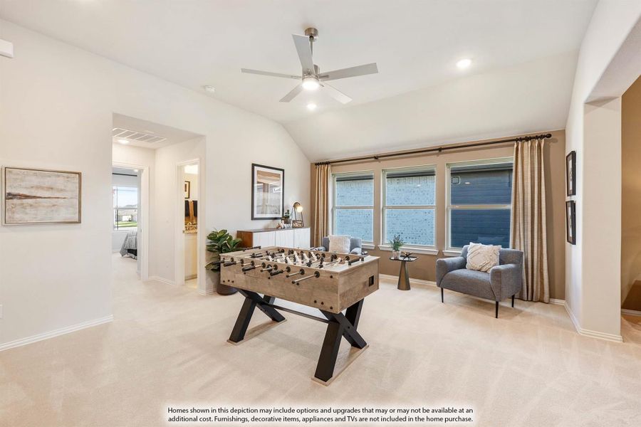 Game room with foosball table, vaulted ceiling, ceiling fan, and carpet flooring Game room with foosball table, vaulted ceiling, ceiling fan, and carpet flooring