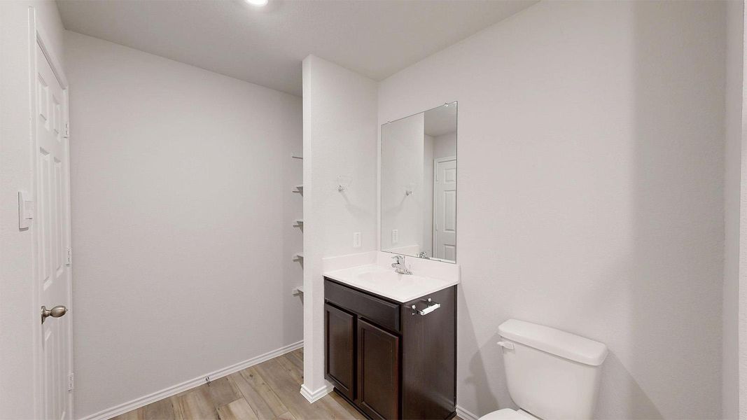 Half bath featuring vanity and light wood-style floors