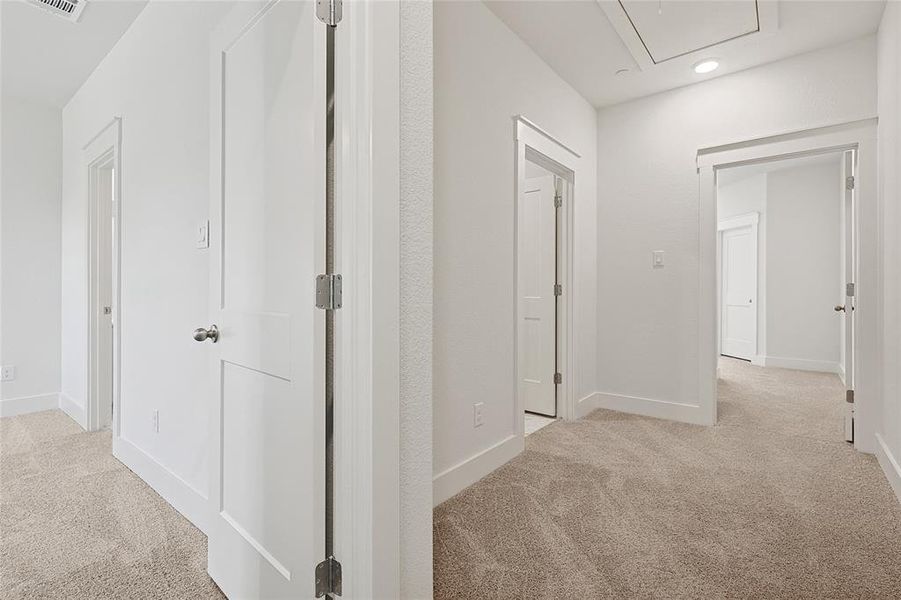 The property features a bright hallway with white walls, white trim, and light-colored carpeting