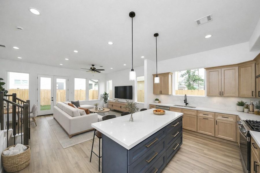 Open-concept kitchen and living area with a large island, modern finishes, and great natural light—ideal for entertaining and everyday living.