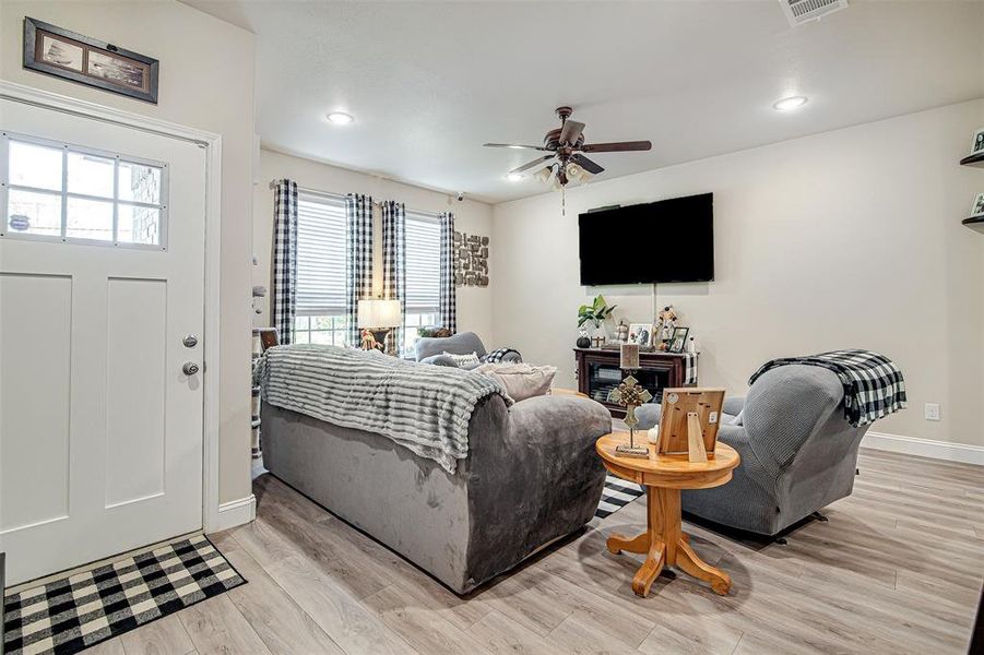 Living room featuring light hardwood / wood-style flooring and ceiling fan