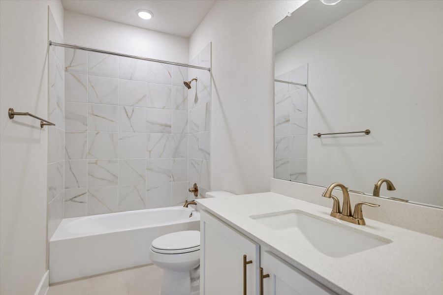 Clean lines and a tiled shower tub alcove define this sleek washroom space. Clean lines and a tiled shower tub alcove define this sleek washroom space.
