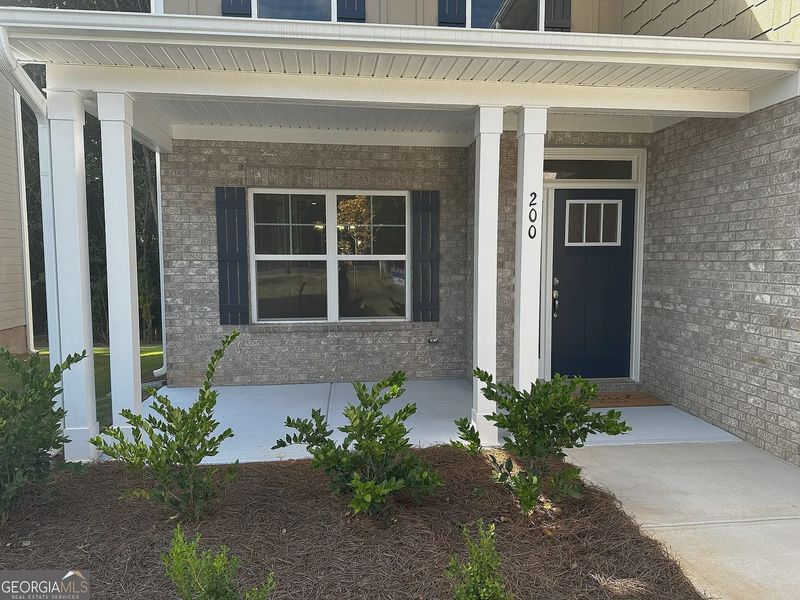 Front exterior of a new home in Canterbury Villas, Carrollton, GA, highlighting curb appeal (Image 2).