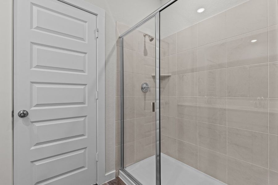 A shower with a glass door. A shower with a glass door.