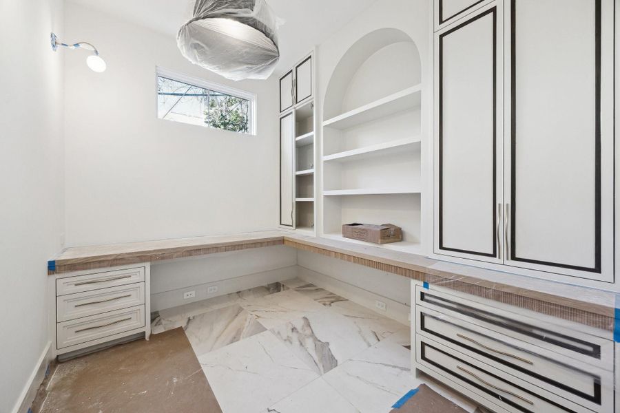 Home Office one the first floor with a built in desk, shleving and drawers.