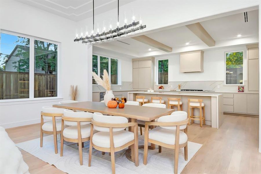 Dining room with light wood-style floors and beam ceiling Dining room with light wood-style floors and beam ceiling