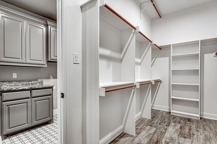 Primary closet walks through from bathroom to utility