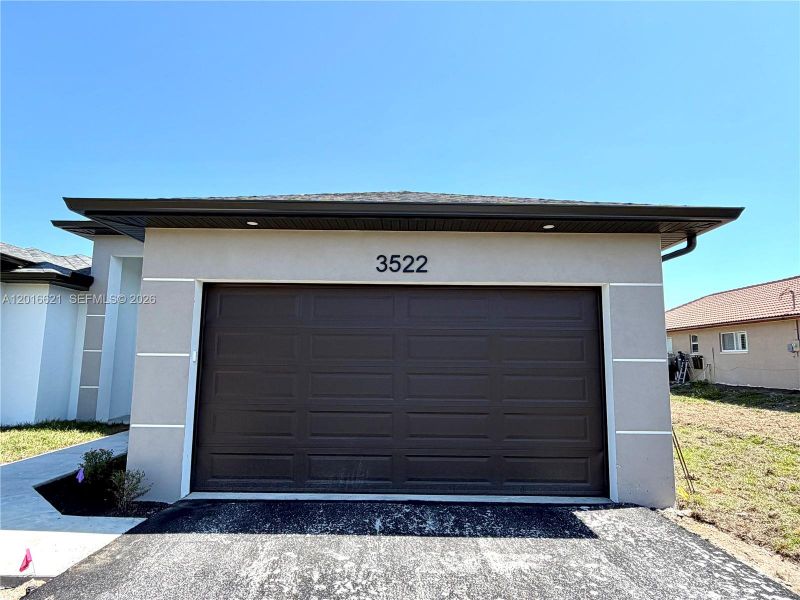 Front exterior of a new home in , Naples, FL, highlighting curb appeal (Image 2). Front exterior of a new home in , Naples, FL, highlighting curb appeal (Image 2).