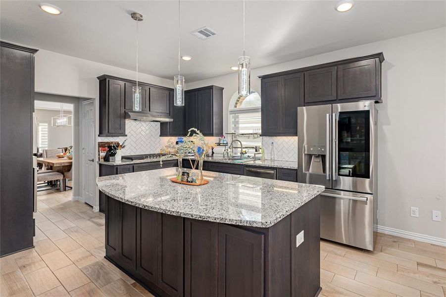 Kitchen featuring a center island, stainless steel appliances, and a wealth of natural light