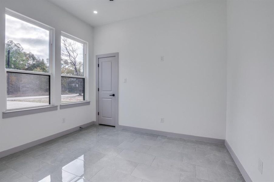 Unfurnished room featuring light tile patterned floors