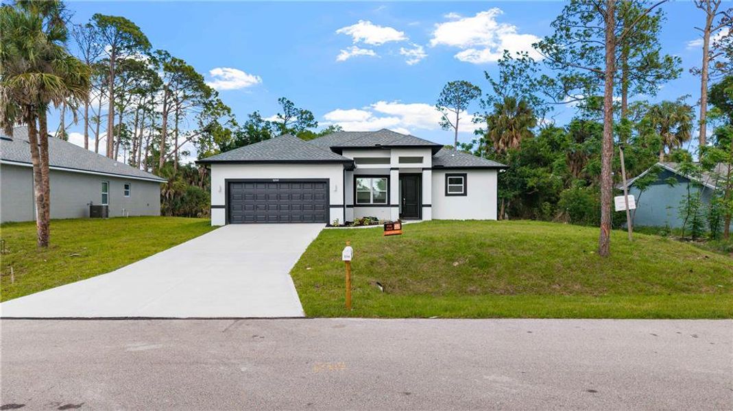 Front exterior of a new home in , North Port, FL, highlighting curb appeal (Image 24).