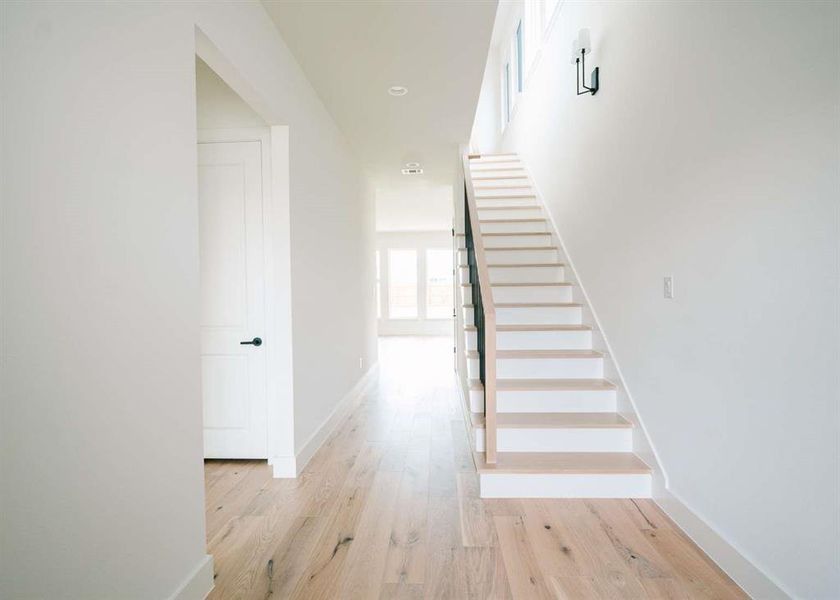 Staircase featuring light hardwood / wood-style floors