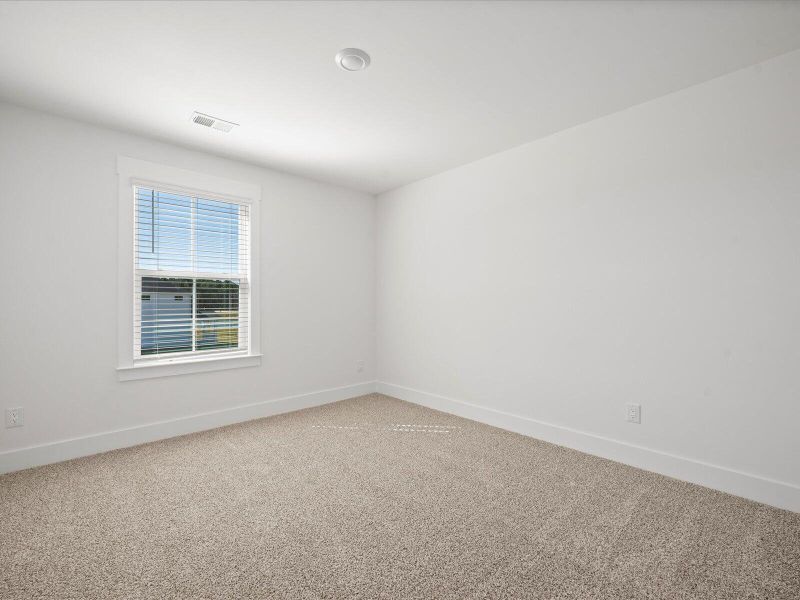 Spacious, unfurnished interior of a new home in The Coves at Lakes of Cane Bay, Summerville (Image 24).