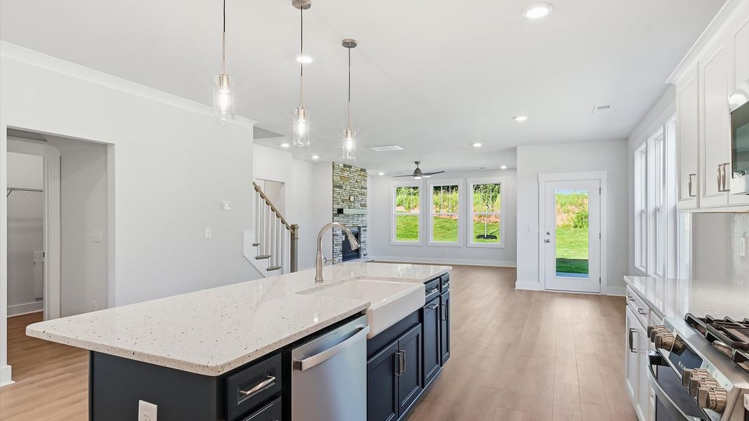 First-class kitchen with a spacious 9-foot island—perfect for entertaining beneath designer pendant lighting by DRB Homes