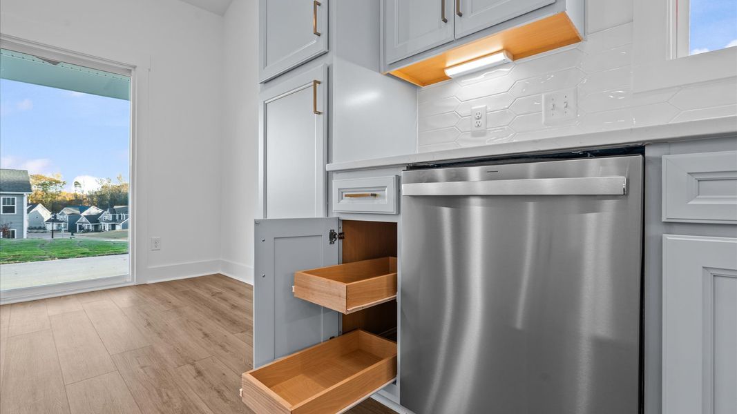 Highly skilled design choices create a clean, open kitchen with a central island