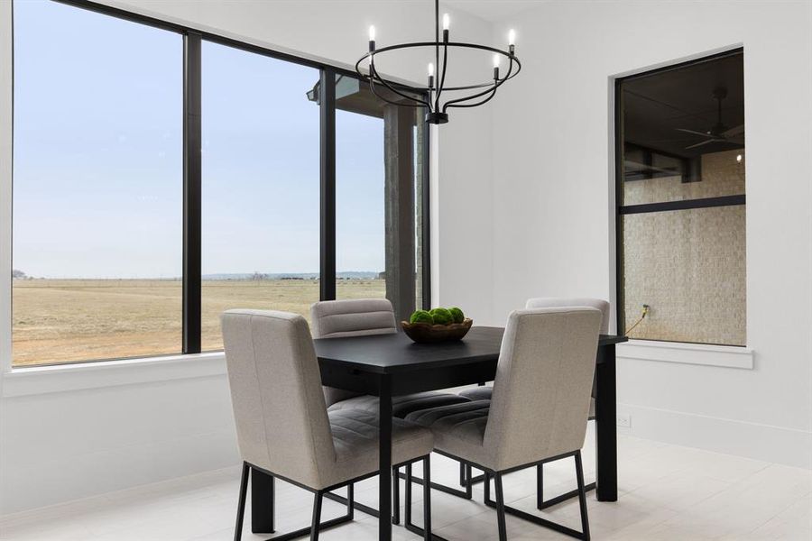 Dining room featuring a rural view and a notable chandelier