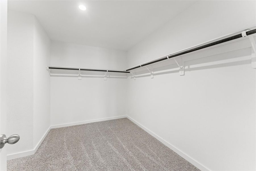 This impressive walk-in closet offers an incredible amount of storage space to keep your wardrobe perfectly organized and accessible.