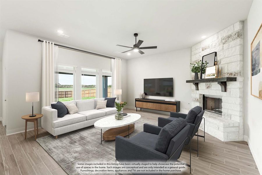Living room with white stone fireplace, ceiling fan, large windows, and wood-look floors Living room with white stone fireplace, ceiling fan, large windows, and wood-look floors