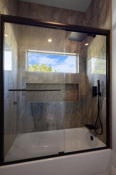 Bathroom with combined bath / shower with glass door