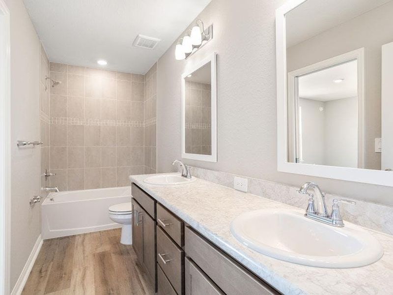 Secondary bedrooms share a Jack-and-Jill bath - Bimini townhome by Highland Homes
