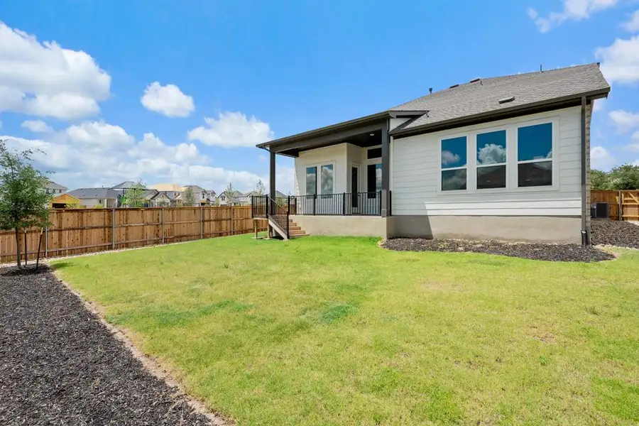 Front exterior of a new home in Park Collection at Heritage, Dripping Springs, TX, highlighting curb appeal (Image 21). Front exterior of a new home in Park Collection at Heritage, Dripping Springs, TX, highlighting curb appeal (Image 21).