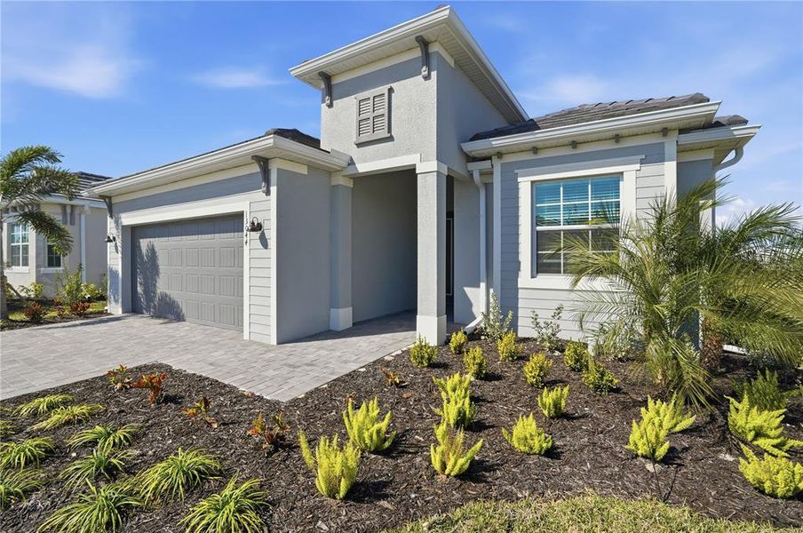 Front exterior of a new home in Wellen Park Golf & Country Club, Venice, FL, highlighting curb appeal (Image 19).