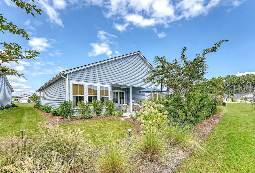 Front exterior of a new home in Horizons at Summers Corner | 55+: The Estates, Summerville, SC, highlighting curb appeal (Image 23).