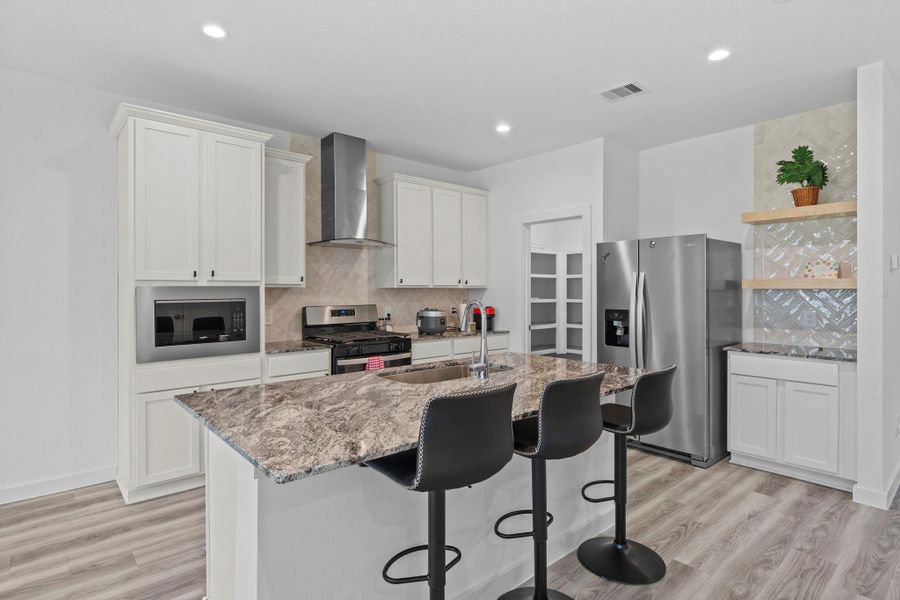 Full size kitchen with a breakfast bar and walk in pantry Full size kitchen with a breakfast bar and walk in pantry