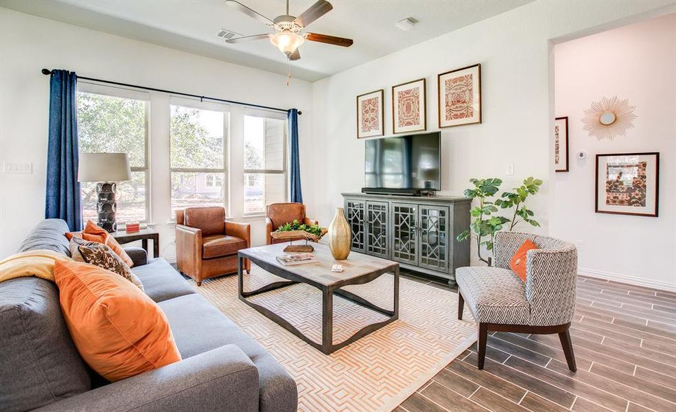 Living room featuring wood tiled floors and ceiling fan Living room featuring wood tiled floors and ceiling fan