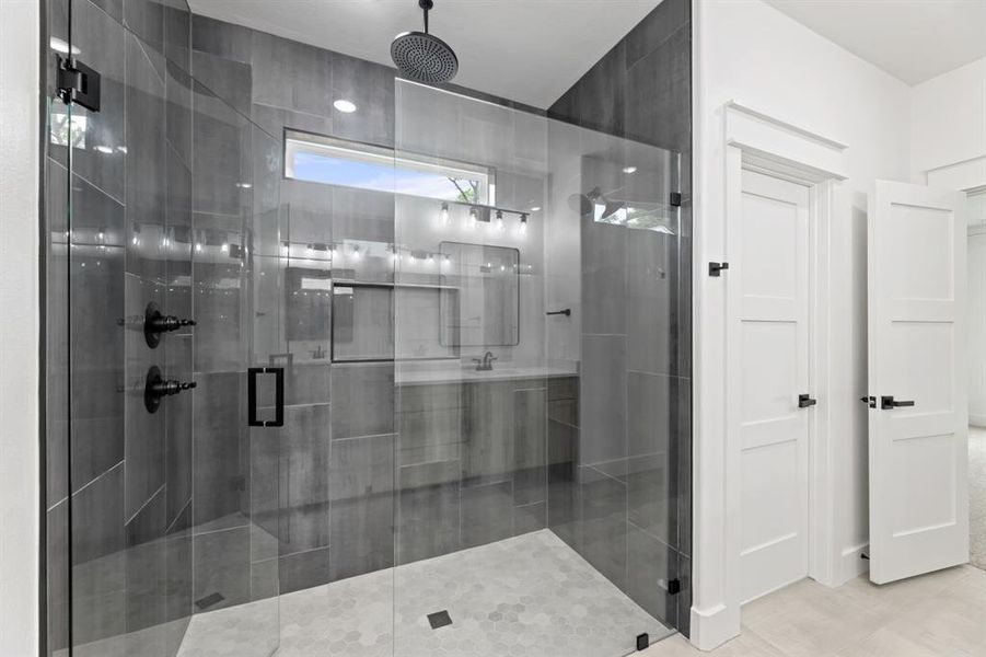 master bathroom featuring tile floors and an enclosed shower