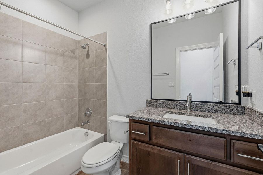 Granite counters and rich wood cabinetry add functional elegance to this well-appointed bathroom. Granite counters and rich wood cabinetry add functional elegance to this well-appointed bathroom.