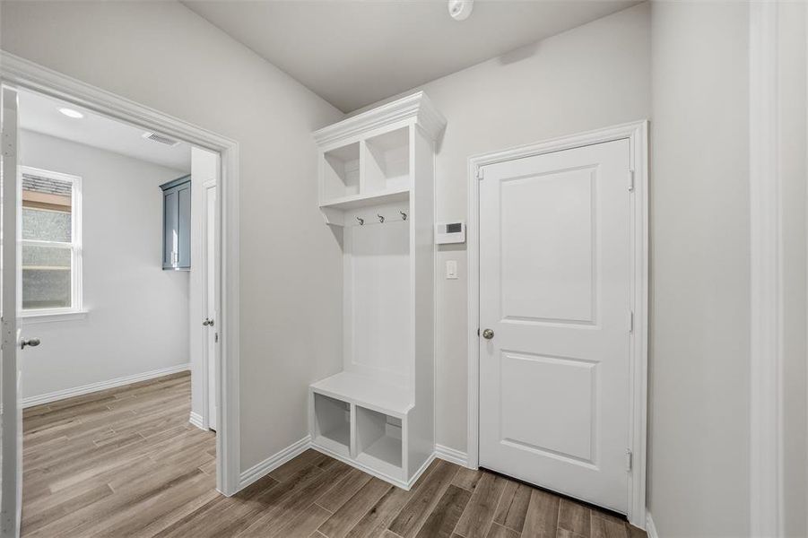 Mudroom with wood finish floors and baseboards Mudroom with wood finish floors and baseboards