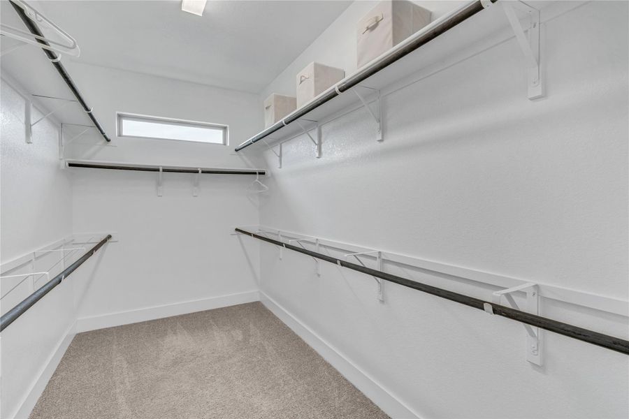 A well-organized walk-in closet offers ample storage space for a refined wardrobe collection.