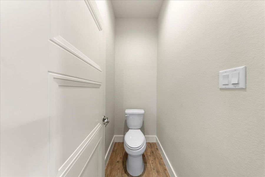 Bathroom with wood finished floors and toilet Bathroom with wood finished floors and toilet