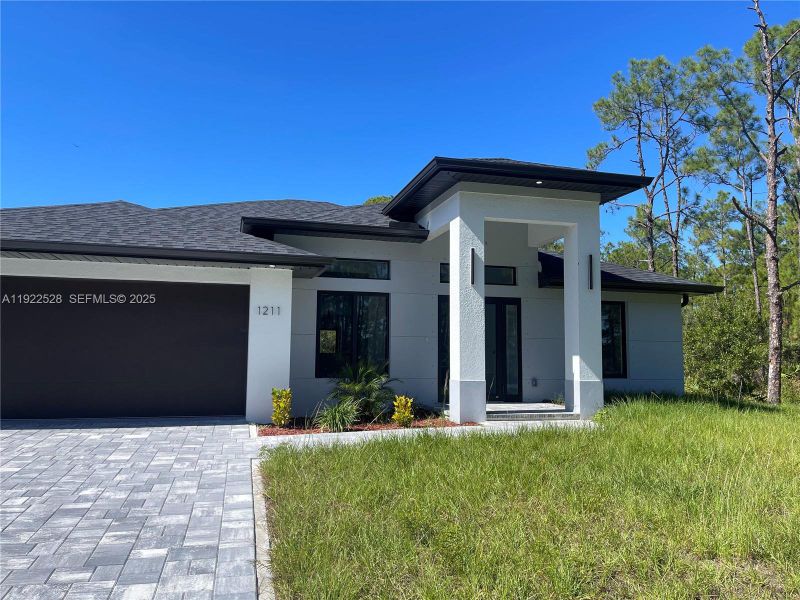 Front exterior of a new home in , Lehigh Acres, FL, highlighting curb appeal (Image 2). Front exterior of a new home in , Lehigh Acres, FL, highlighting curb appeal (Image 2).