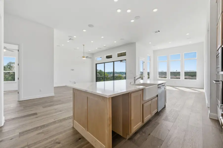 Kitchen with open floor plan, light brown cabinets, plenty of natural light, and recessed lighting