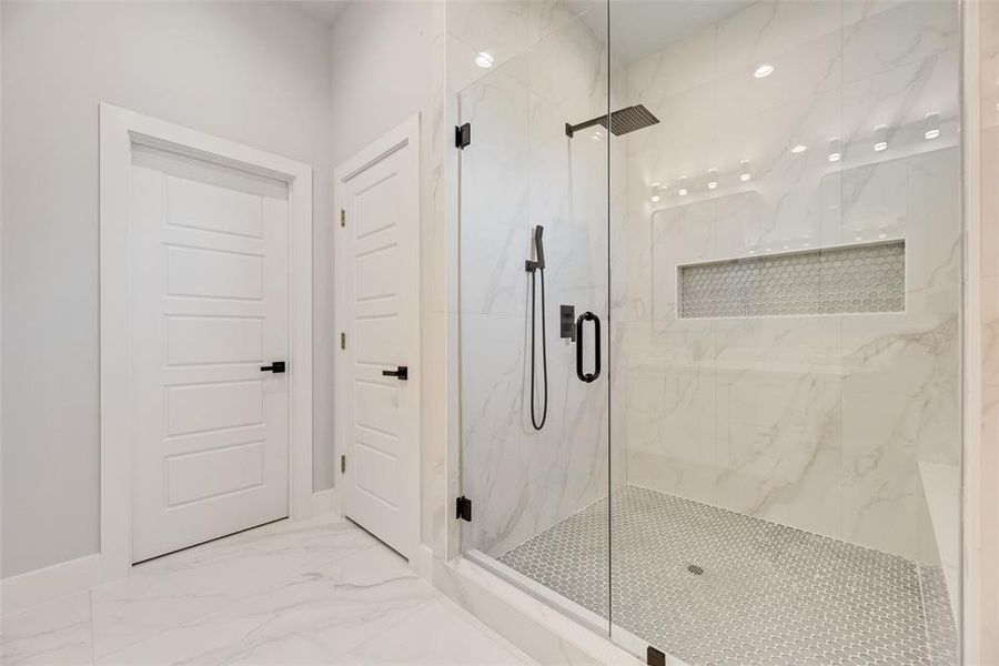 Full bathroom with light marble finish floors, a marble finish shower, and recessed lighting Full bathroom with light marble finish floors, a marble finish shower, and recessed lighting