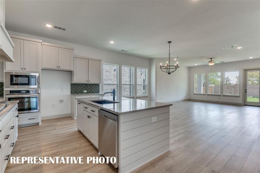 Your new home is filled with natural light from walls of windows that bring the outside in!  REPRESENTATIVE PHOTO